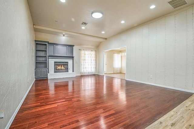 unfurnished living room with dark hardwood / wood-style floors and a fireplace