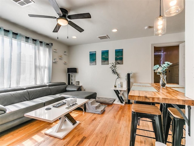 living room featuring ceiling fan and light wood-type flooring