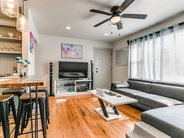 living room with hardwood / wood-style flooring and ceiling fan