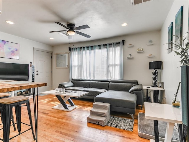 living room featuring hardwood / wood-style flooring and ceiling fan