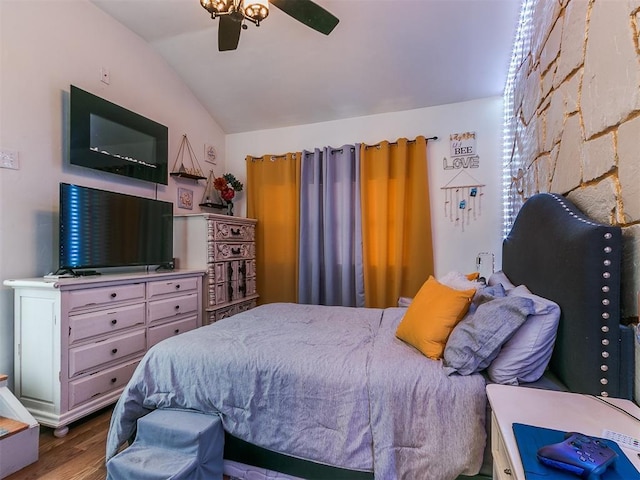 bedroom featuring ceiling fan, hardwood / wood-style floors, and lofted ceiling