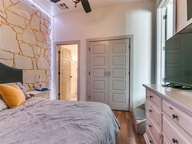 bedroom featuring hardwood / wood-style floors, ceiling fan, and a closet