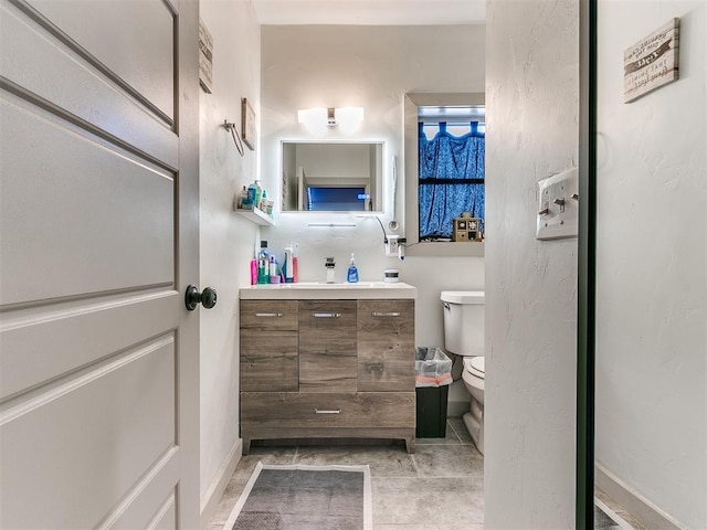 bathroom with tile patterned floors, vanity, and toilet