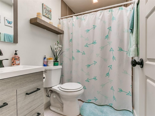 bathroom with tile patterned flooring, vanity, toilet, and curtained shower