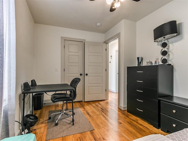 home office featuring light hardwood / wood-style floors and ceiling fan