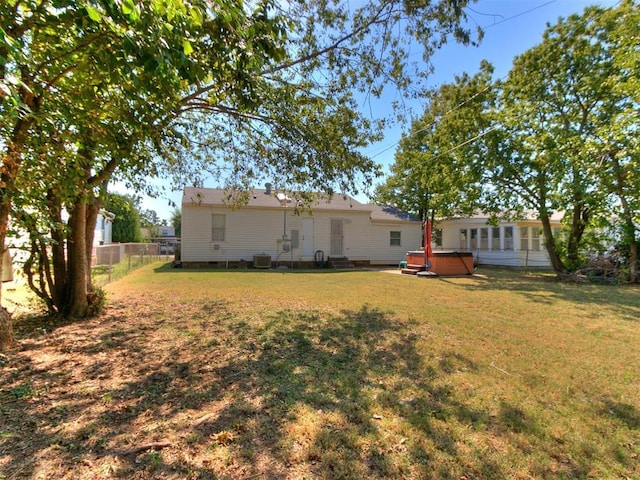 view of yard with a hot tub and central AC unit