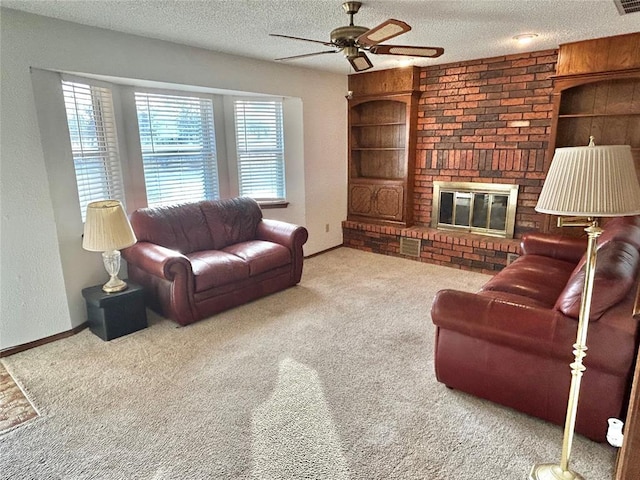 carpeted living room featuring ceiling fan, a textured ceiling, and a brick fireplace