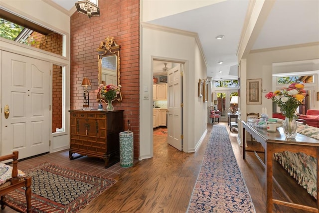 foyer with french doors, dark wood-type flooring, brick wall, and ornamental molding