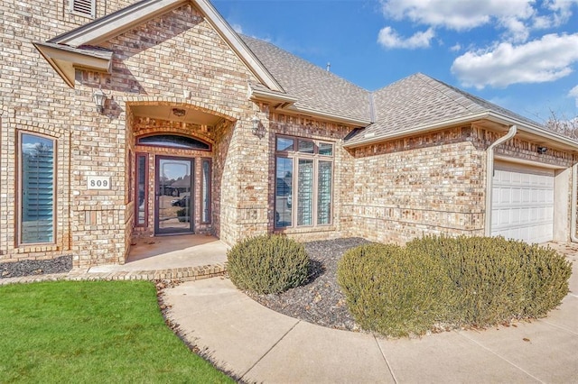 doorway to property with a garage