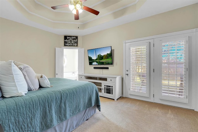 carpeted bedroom with access to outside, a raised ceiling, ceiling fan, and crown molding