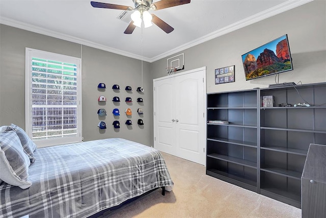 bedroom with carpet flooring, a closet, ceiling fan, and ornamental molding