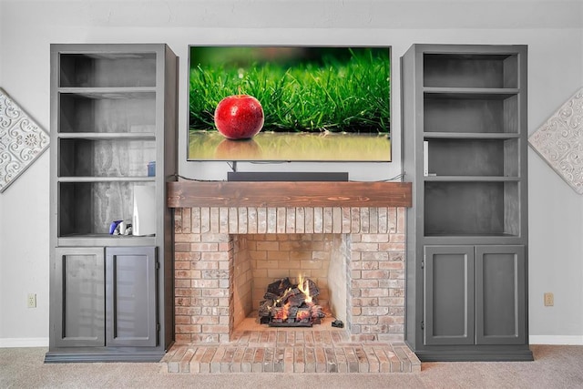 room details with carpet, built in shelves, and a brick fireplace