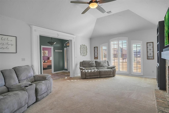 living room with ceiling fan, carpet, lofted ceiling, and a brick fireplace