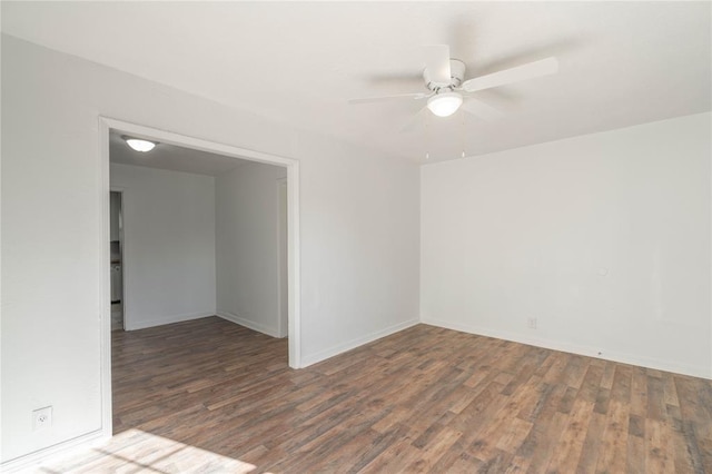 empty room featuring ceiling fan and dark hardwood / wood-style flooring