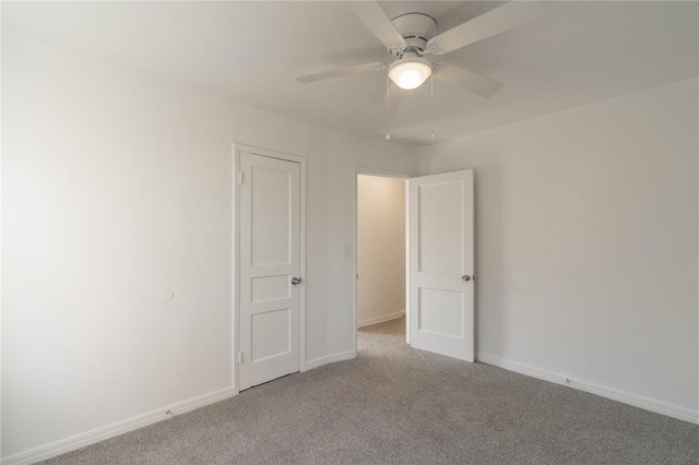 spare room with light colored carpet and ceiling fan