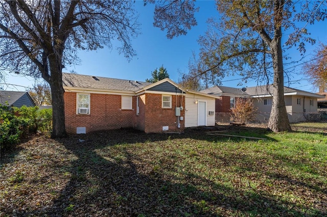 rear view of property with a yard