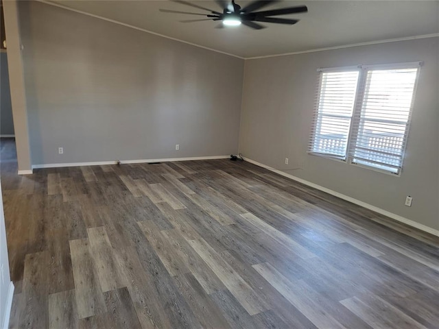 spare room featuring dark hardwood / wood-style flooring, ceiling fan, and crown molding