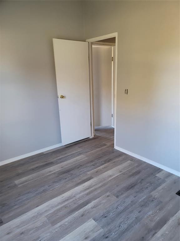 unfurnished room with hardwood / wood-style flooring