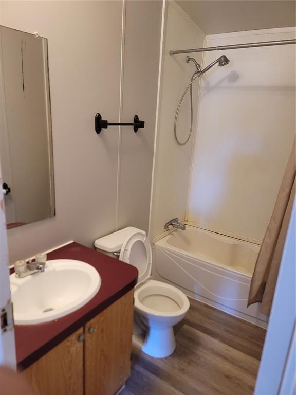 full bathroom featuring hardwood / wood-style flooring, shower / bath combo, toilet, and vanity