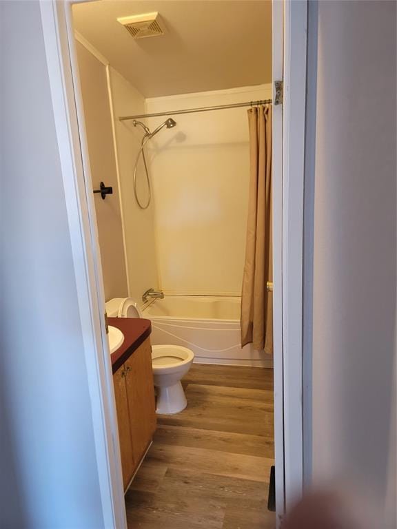 full bathroom with hardwood / wood-style floors, vanity, toilet, and shower / bath combo