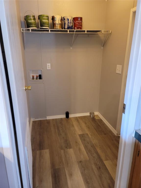 laundry area with hardwood / wood-style floors and washer hookup