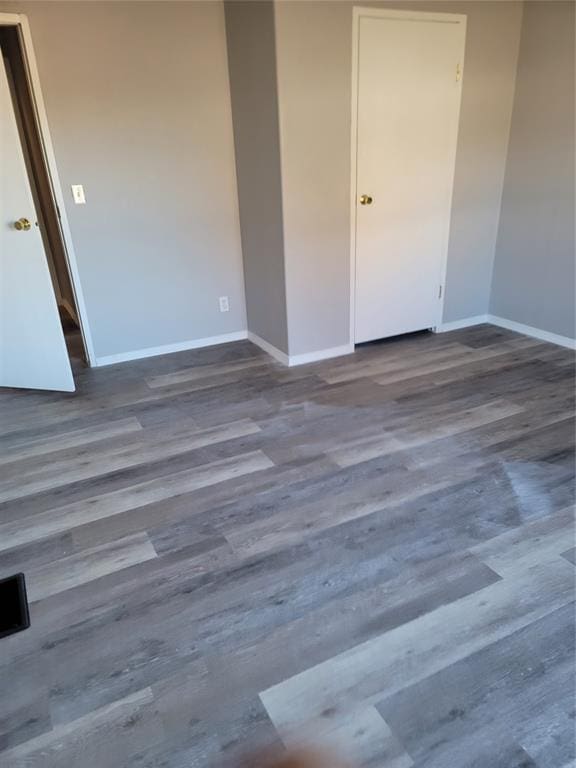 empty room with dark hardwood / wood-style floors