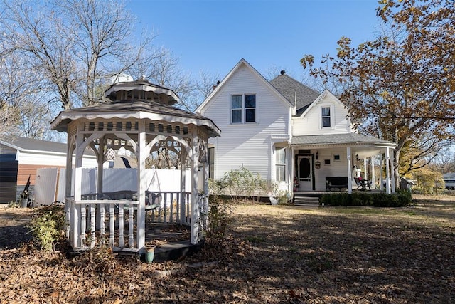 rear view of house featuring a gazebo and covered porch