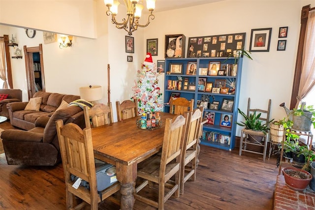 dining room featuring dark wood-type flooring and an inviting chandelier