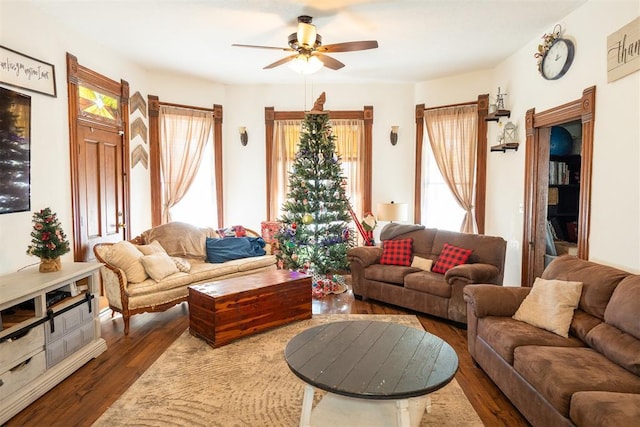 living room with ceiling fan and dark wood-type flooring