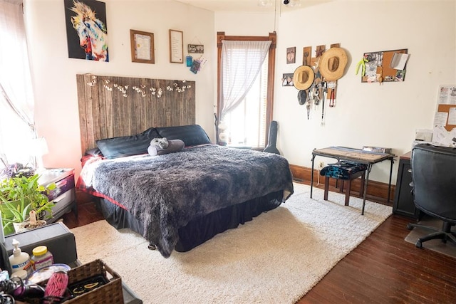 bedroom with dark hardwood / wood-style flooring