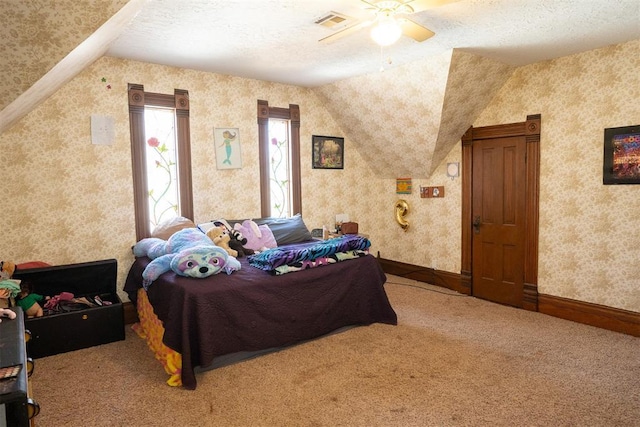 carpeted bedroom with ceiling fan, a textured ceiling, and vaulted ceiling