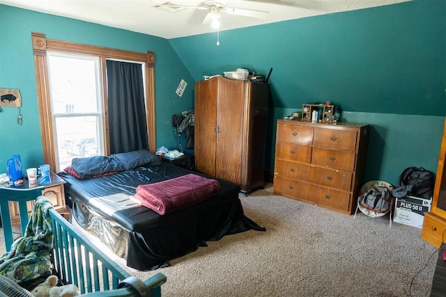 bedroom featuring carpet, ceiling fan, and vaulted ceiling