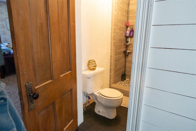 bathroom featuring a shower and toilet