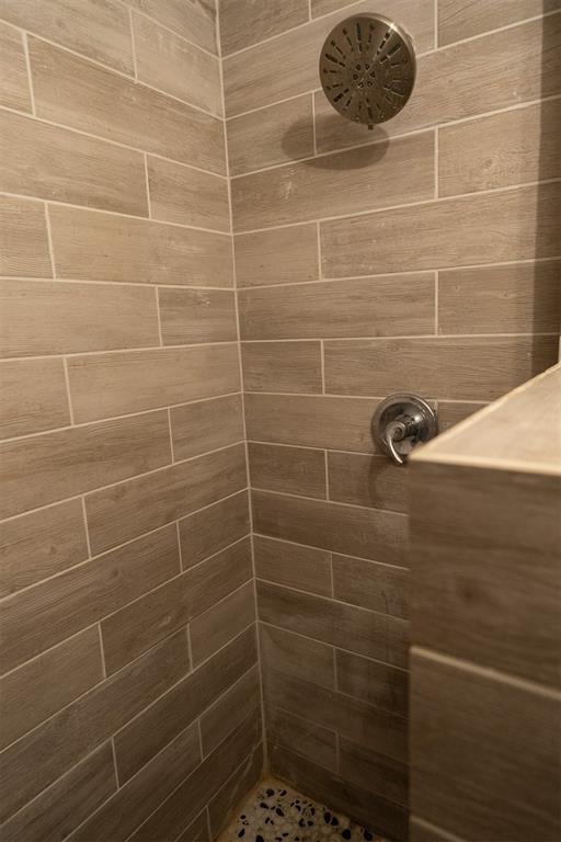 bathroom with a tile shower