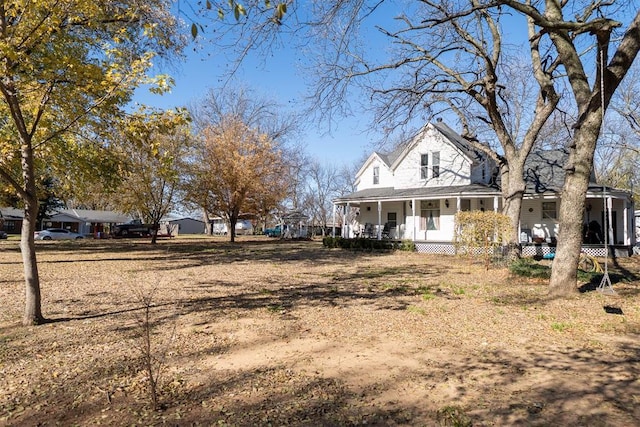 view of yard featuring covered porch