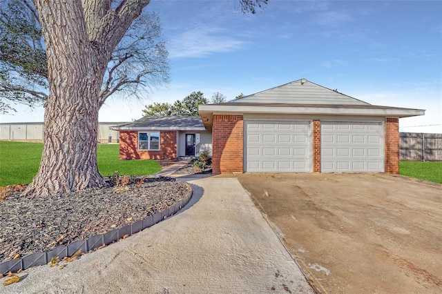 ranch-style house featuring a front yard and a garage