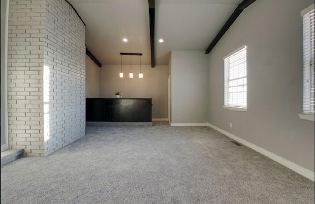 interior space with beamed ceiling and light colored carpet