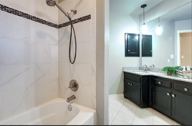 bathroom featuring vanity and tiled shower / bath