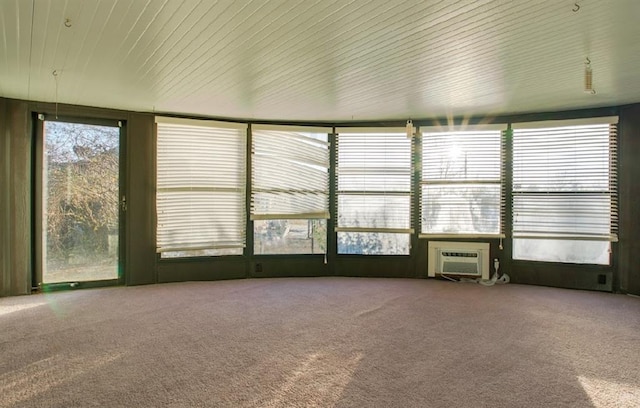 unfurnished sunroom featuring an AC wall unit