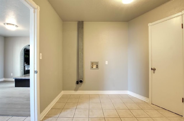 laundry area featuring hookup for a washing machine and light tile patterned flooring