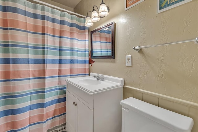 bathroom with vanity, toilet, and walk in shower