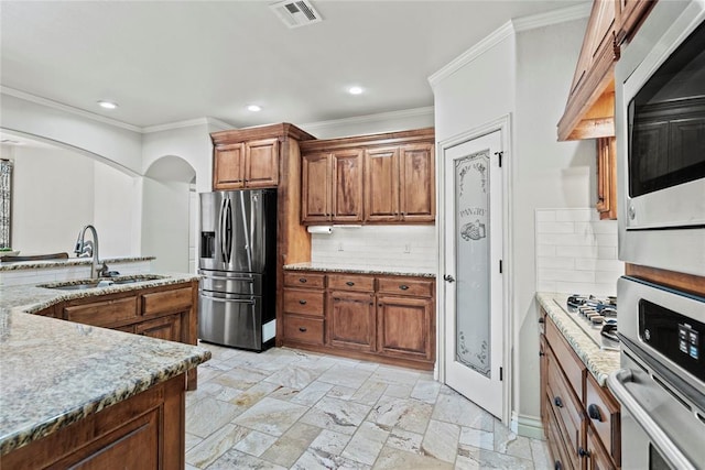 kitchen featuring backsplash, stainless steel appliances, ornamental molding, and sink