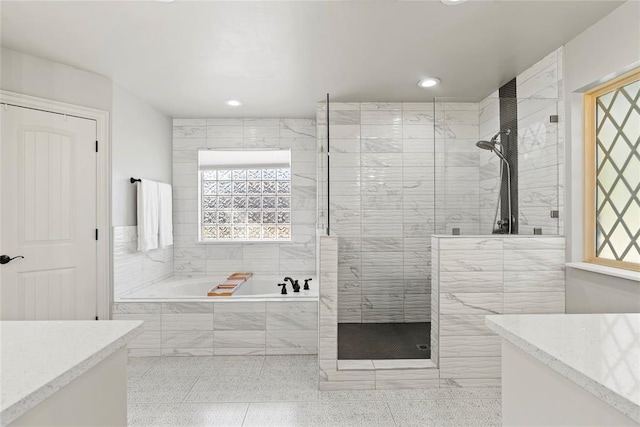 bathroom featuring tile patterned flooring, vanity, and independent shower and bath