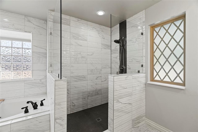 bathroom with separate shower and tub