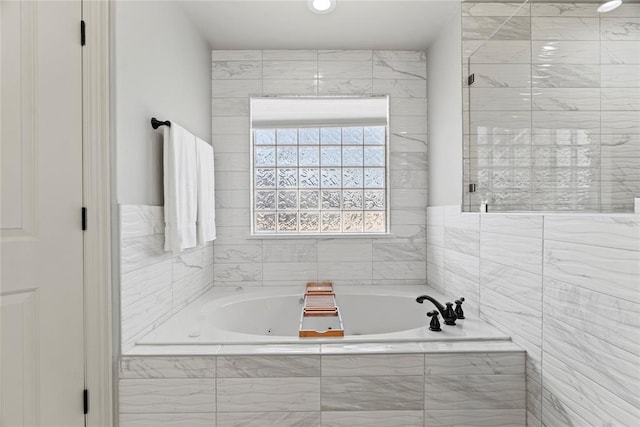 bathroom with separate shower and tub