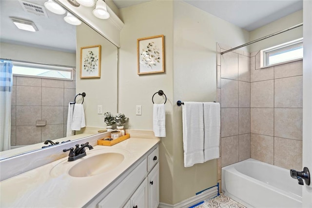 bathroom featuring plenty of natural light, vanity, and shower / tub combo with curtain