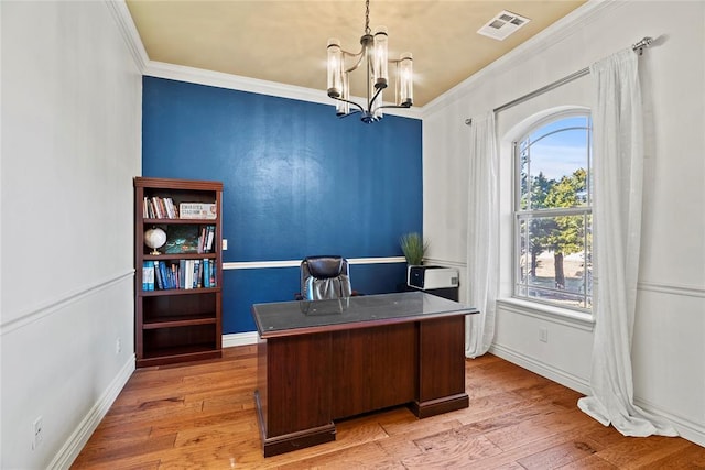 office featuring light hardwood / wood-style flooring, a notable chandelier, and crown molding