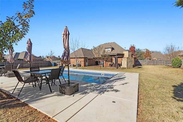 view of pool featuring a patio area and a yard