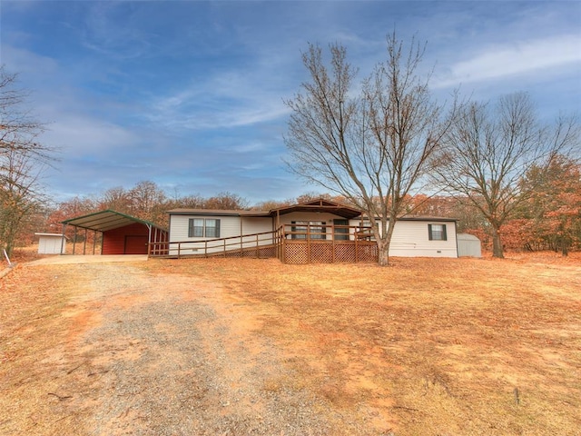 ranch-style home featuring a deck and a carport