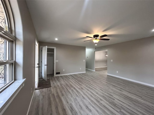 empty room with ceiling fan and wood-type flooring